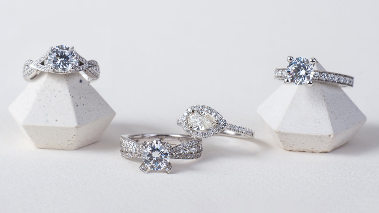 4 diamond engagement rings on a white background.